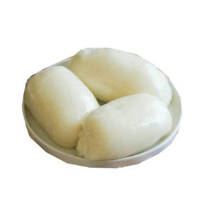 Three pieces of white fufu on a white plate with a white background